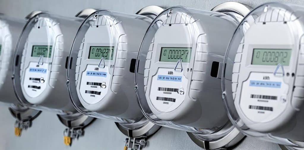 A row of digital water meters displaying readings