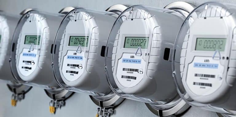 A row of digital water meters displaying readings